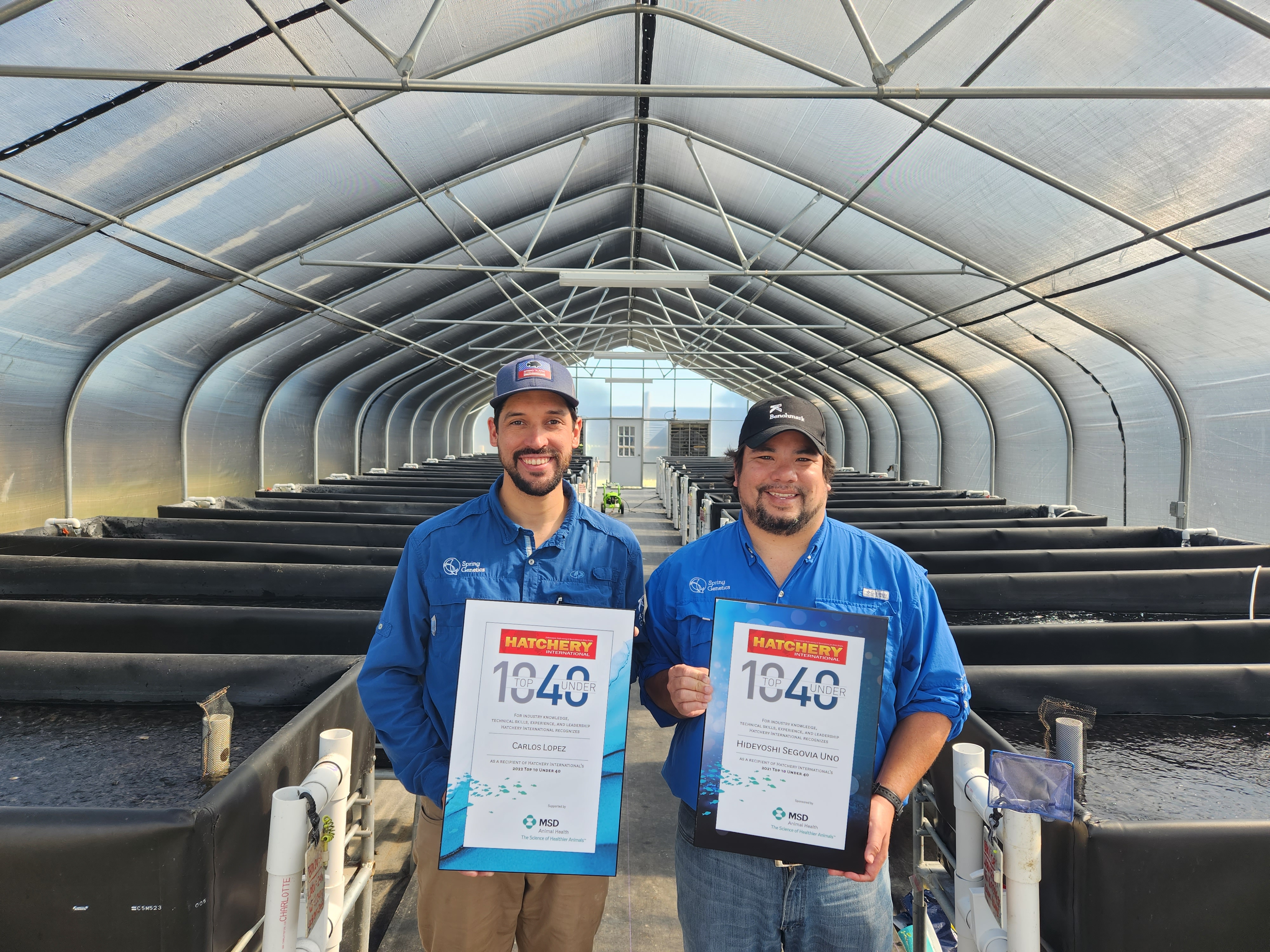 Carlos Lopez and Hideyoshi Segovia holding awards